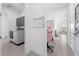 Hallway leading to the laundry area, featuring a work station and an open view of the living room at 13589 Mcmillan Dr, Orlando, FL 32827