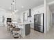 Modern kitchen with stainless steel appliances, pendant lighting, and a center island with seating, perfect for cooking at 13589 Mcmillan Dr, Orlando, FL 32827