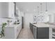 Contemporary kitchen featuring stainless steel appliances, a sleek island with seating, and modern lighting fixtures at 13589 Mcmillan Dr, Orlando, FL 32827