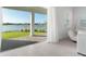 Living room that shows the beautiful outdoor views of a lake through sliding glass doors leading to the patio at 13589 Mcmillan Dr, Orlando, FL 32827