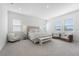 Spacious main bedroom featuring ample natural light, a comfortable bed, and stylish seating area with views at 13589 Mcmillan Dr, Orlando, FL 32827