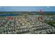 Expansive aerial shot showcasing community layout with residential homes, clubhouse amenities and scenic lakes, all under clear skies at 14602 Winter Stay Dr, Winter Garden, FL 34787