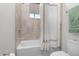 Clean bathroom with a bathtub, shower with curtain, beige tile and modern fixtures at 14602 Winter Stay Dr, Winter Garden, FL 34787