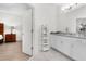 Bright bathroom with white cabinets, granite countertops, and vanity, showcasing neutral tile flooring at 14602 Winter Stay Dr, Winter Garden, FL 34787