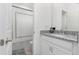 Well-lit bathroom with a granite countertop, white cabinets, and a shower with a curtain at 14602 Winter Stay Dr, Winter Garden, FL 34787