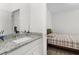Bathroom featuring granite countertops, modern fixtures, and a mirror with decorative lighting at 14602 Winter Stay Dr, Winter Garden, FL 34787