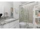 Modern bathroom with white cabinets, granite counters and updated shower with seamless glass doors at 14602 Winter Stay Dr, Winter Garden, FL 34787