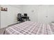 Bright bedroom with wood laminate floors, a large closet, and a workspace with a computer desk at 14602 Winter Stay Dr, Winter Garden, FL 34787