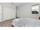 Cozy bedroom featuring a large closet, wood laminate floors, and a comfortable queen size bed at 14602 Winter Stay Dr, Winter Garden, FL 34787