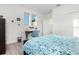 Bright bedroom featuring a desk, chair, and a comfortable bed with blue floral patterned bedding at 14602 Winter Stay Dr, Winter Garden, FL 34787