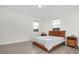 Bright bedroom featuring wood laminate floors, two windows, and a comfortable queen size bed at 14602 Winter Stay Dr, Winter Garden, FL 34787