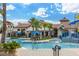 Resort-style community pool and splash pad with palm trees, lounge chairs, and inviting seating areas for relaxation at 14602 Winter Stay Dr, Winter Garden, FL 34787