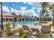 Inviting community pool with poolside lounge chairs, umbrellas, and playful water features, perfect for leisure and recreation at 14602 Winter Stay Dr, Winter Garden, FL 34787