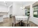 Well-lit dining area featuring a round table and chairs with view to the outdoors through a bright window at 14602 Winter Stay Dr, Winter Garden, FL 34787