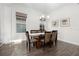 Formal dining room with modern table, seating for eight, stylish chandelier, and natural light, perfect for entertaining at 14602 Winter Stay Dr, Winter Garden, FL 34787