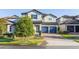 Two-story home featuring a tile roof, brick driveway, blue shutters and a two-car garage at 14602 Winter Stay Dr, Winter Garden, FL 34787