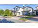 Charming two-story home with a brick driveway, blue accents, and a covered front porch at 14602 Winter Stay Dr, Winter Garden, FL 34787