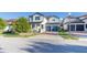 Charming two-story home with a brick driveway, blue accents, and a covered front porch at 14602 Winter Stay Dr, Winter Garden, FL 34787