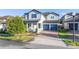 Two-story home featuring a tile roof, brick driveway, blue shutters and a two-car garage at 14602 Winter Stay Dr, Winter Garden, FL 34787