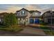 Two-story home featuring a tile roof, brick driveway, blue shutters and a two-car garage at 14602 Winter Stay Dr, Winter Garden, FL 34787