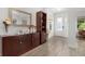 Elegant foyer with hardwood floors, decorative mirror and tasteful furnishings creating a welcoming entrance to the home at 14602 Winter Stay Dr, Winter Garden, FL 34787