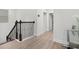 Bright hallway with wood floors, iron railing and transom window above the doors at 14602 Winter Stay Dr, Winter Garden, FL 34787