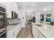 Modern kitchen featuring granite countertops, stainless appliances, ample cabinet space, and wood flooring at 14602 Winter Stay Dr, Winter Garden, FL 34787