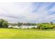 Scenic view of a calm lake surrounded by lush greenery and residential homes, creating a tranquil and inviting landscape at 14602 Winter Stay Dr, Winter Garden, FL 34787