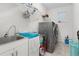 Efficient laundry room equipped with modern washer, dryer, sink, and ample storage at 14602 Winter Stay Dr, Winter Garden, FL 34787
