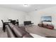 Modern living room with gray plank flooring, updated furniture, and a large TV at 14602 Winter Stay Dr, Winter Garden, FL 34787