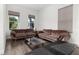 Bright living room with hardwood floors, plush sofas and large windows that offer a view of the greenery at 14602 Winter Stay Dr, Winter Garden, FL 34787