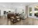 Open concept living room and kitchen featuring lots of natural light and access to outdoor sitting area at 14602 Winter Stay Dr, Winter Garden, FL 34787