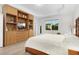 Main bedroom with tray ceiling, built-in shelves, and large windows at 14602 Winter Stay Dr, Winter Garden, FL 34787