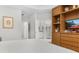 Bright main bedroom featuring an ensuite bathroom, a built-in bookshelf, and a neutral color palette at 14602 Winter Stay Dr, Winter Garden, FL 34787