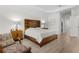 Large main bedroom with wood floors and custom bed frame, complemented by designer lamps at 14602 Winter Stay Dr, Winter Garden, FL 34787