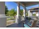 Inviting front porch with gray columns, white railings, and seating perfect for relaxing and enjoying neighborhood views at 14602 Winter Stay Dr, Winter Garden, FL 34787