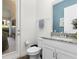Elegant powder room with granite countertop and stylish fixtures, conveniently located near the entry at 14602 Winter Stay Dr, Winter Garden, FL 34787