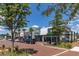 A landscaped view of several store fronts with parking, including an Apple store and pizza restaurant at 14602 Winter Stay Dr, Winter Garden, FL 34787