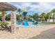 Modern splash pad with playful water features and lounge chairs, offering a refreshing and entertaining recreational space at 14602 Winter Stay Dr, Winter Garden, FL 34787