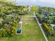 Aerial view featuring a playground and picnic shelter on a large green space in a lush landscape by the water at 1475 Warrior Trl, Enterprise, FL 32725