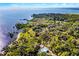 Stunning aerial view of waterfront homes surrounded by nature with calming water views at 1475 Warrior Trl, Enterprise, FL 32725