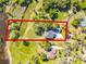 Aerial view of the property showcasing its location near the lake and lush greenery at 1475 Warrior Trl, Enterprise, FL 32725