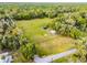 Aerial view of community recreational area with playground, pavilion, and firepit surrounded by green spaces and trees at 1475 Warrior Trl, Enterprise, FL 32725