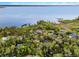 Panoramic aerial view of lakefront homes surrounded by lush trees and breathtaking water views at 1475 Warrior Trl, Enterprise, FL 32725
