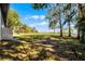 Lush backyard with view of lake and trees at 1475 Warrior Trl, Enterprise, FL 32725