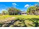 View of the house with sprawling backyard and lake at 1475 Warrior Trl, Enterprise, FL 32725