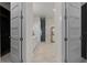 Hallway view of this bright bathroom boasting dual sinks, walk-in shower, and modern finishes at 1475 Warrior Trl, Enterprise, FL 32725