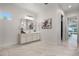 Bright bathroom boasts a white vanity with a large mirror and scenic views from the window at 1475 Warrior Trl, Enterprise, FL 32725