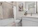 Bright bathroom with quartz countertop, contemporary vanity and tiled tub at 1475 Warrior Trl, Enterprise, FL 32725