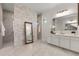 Elegant bathroom features a spacious shower, large mirror, and stylish gray and white stone accent wall at 1475 Warrior Trl, Enterprise, FL 32725